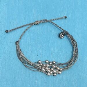Grey Pura Vida bracelet with silver tone beads.